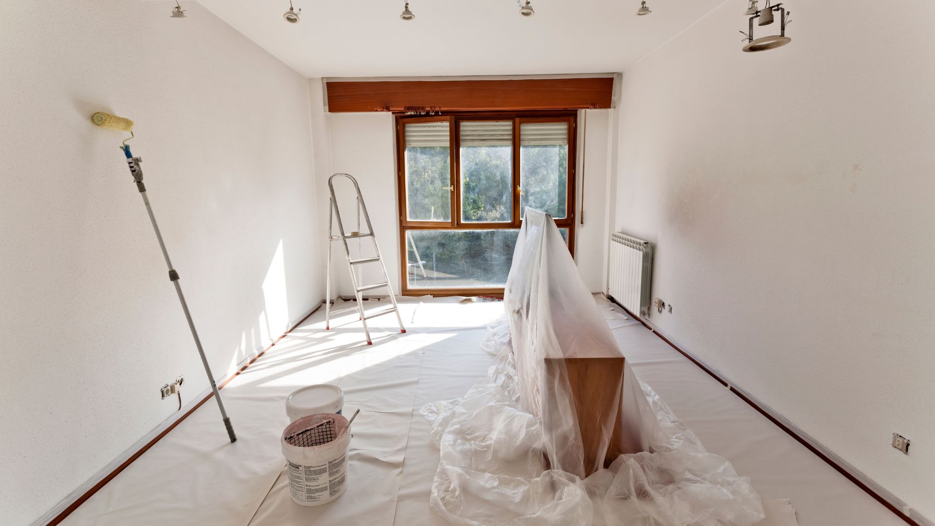 A room that has a lot of white paint on the floor